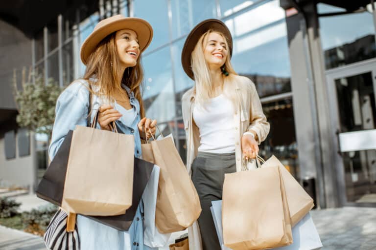 Two girls out shopping holding shopping bags