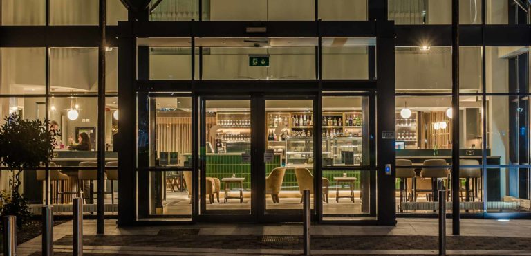 The Hoban Hotel Kilkenny exterior at night looking into lobby