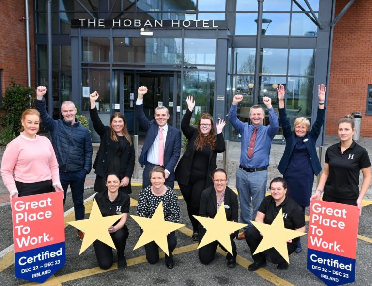 Staff at the Hoban Hotel with 4 stars and great place to work signs