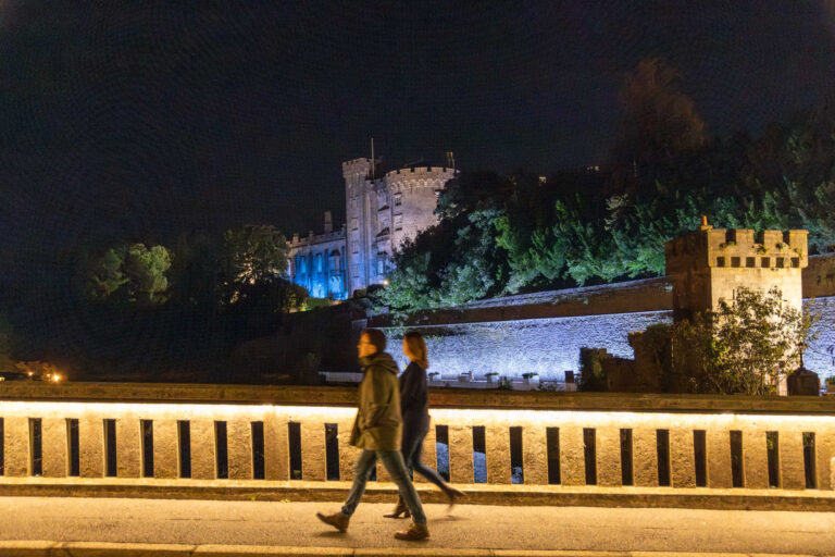Kilkenny City at night couple walking past Kilkenny Castle